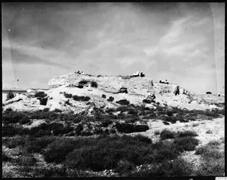 Bamboula mound at Kition seen from the southeast, with several people sitting along its top