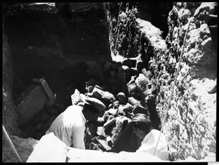 Kristos and Alfred Westholm digging among sculpture fragments in a trench at Kition.