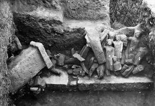 Statues lying in situ among fallen stones in the cult room at Kition