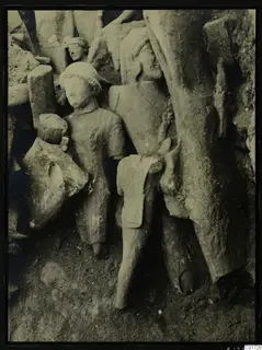 Stone statues standing in situ among fallen blocks in the cult room at Kition