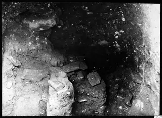 Excavated cult room at Kition with stone blocks and a head sculpture in situ
