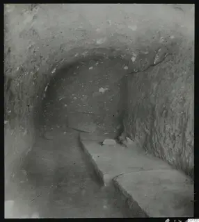 Excavated gallery at Kition with flat stone benches along its side and floor