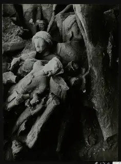 Carved stone sculptures, heads and body fragments piled together in the big deposit in the cult room at Kition