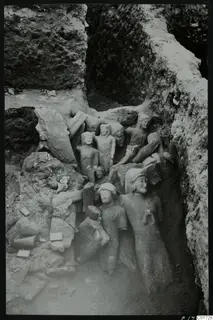 Large stone sculptures packed together in the cult room deposit at Kition, partly excavated