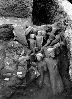 Larger sculptures lying together in the cult room deposit at Kition, with fallen blocks and earth around them