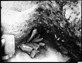 Detail of the big deposit in the cult room at Kition, showing a cluster of worked fragments lying in a hollow dug into soil.