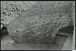 Soil section through the cult room at Kition, seen from the west, showing a rounded mass of earth and stone.