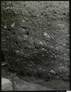 Soil profile in the cult room at Kition, seen from the east, with a stone block at lower left.