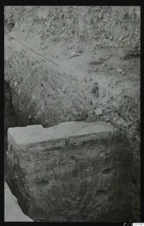 Excavation trench at Kition with a large squared stone block set against a soil section.