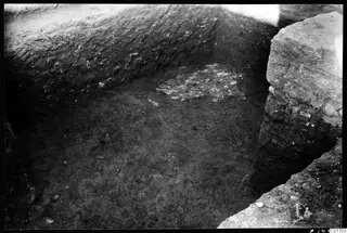 Excavated corner of a cult room at Kition, with a patch of broken floor material lying in the trench