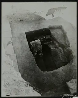 Central pit at Kition, excavated from the east, with large stones and rubble lying inside the cut.