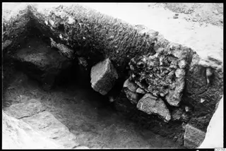 Longitudinal profile of the central pit, showing soil layers and stones in the excavated face.