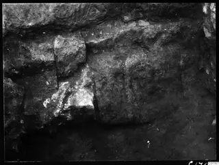 Paraskevi stones in the central pit at Kition: large rough-hewn stone blocks forming a wall in excavated earth.