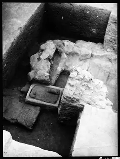 Excavation at Kition showing a stone-framed slab and large rubble blocks in a trench
