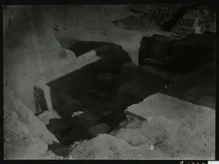 Excavated area at Kition below the cult room, seen from the east, with cut stone blocks and a stone wall