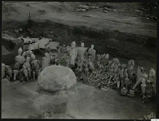 Excavation at Ayia Irini with many clay figures and fragments lying in situ in the trench