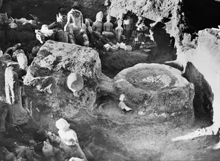 Altar from the northeast at Ayia Irini, with a round stone base and many figurines and statues in the excavated area