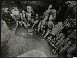 Clay figurines, animal shapes and cylindrical stands lying in excavation square L 9-10 at Ayia Irini