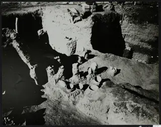 In situ pottery vessels lying in an excavated trench at Ayia Irini