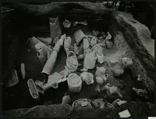 Excavation square K 10 at Ayia Irini, with pale clay vessels and figurines lying in situ in the trench.