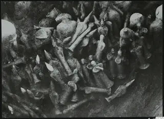 In-situ find of clay figurines packed together in soil during excavation at Ayia Irini