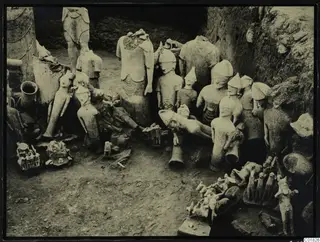 Western part of the votive deposit at Ayia Irini, with many figures lying and standing in an excavated trench