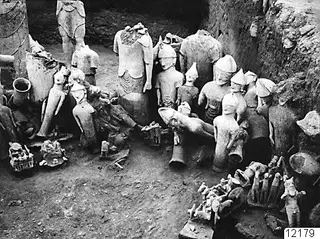 Western part of the votive deposit at Ayia Irini, with many pale figures and statues packed into an excavated pit