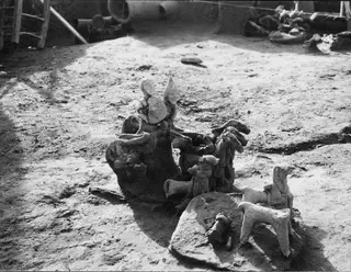Terracotta figurines of humans and animals lying in situ on an excavated ground surface at Ayia Irini