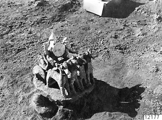 In situ find at Ayia Irini: a group of small modelled figures on a rounded base, lying in excavated soil