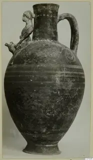 Bichrome-Red pottery jug with a modelled figure on the shoulder, photographed from the side