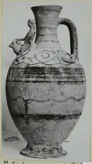 Pottery jug, White Painted VI, with dark painted bands, spiral motifs and a modelled figure applied to the shoulder