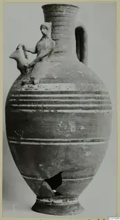 Bichrome-Red jug with a small figure on the shoulder and a bird-headed spout