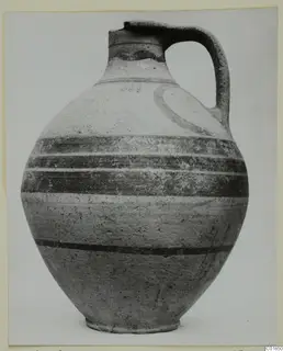 White Painted VI jug with a single loop handle and dark painted bands, shown against a plain background