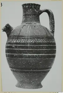 Jug with a head-shaped spout, a loop handle and painted bands, including a cross-hatched band on the body, from Marion