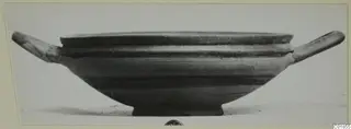 Shallow pottery bowl with two horizontal handles and a ring foot, seen from the side