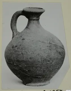 Pottery jug from Marion with a single loop handle and cracked body
