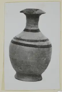 Pottery White Painted VII vessel with a flared mouth, tall neck and dark painted bands on its body