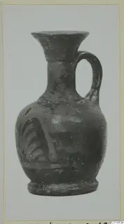 Small jug with a flared mouth and strap handle, with painted strokes on its body, from Marion.