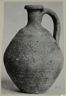 Pottery Plain White VI juglet with a flat rim and a single loop handle