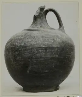 Globular jug from Marion with a strap handle and broken spout