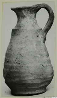 Pottery jug with a single loop handle and grooved lower body, from Marion