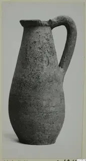 Pottery Plain White VI jug with a single strap handle and flared rim, from the Marion tomb finds