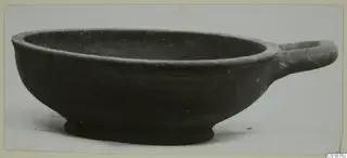 Pottery bowl with a single horizontal handle, from tombs at Marion, shown in side view.