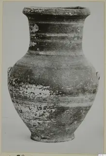 Pottery amphora with a flared rim, two small handles and a ring base, photographed alone