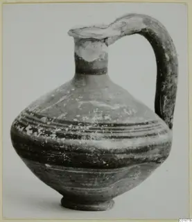 Jug from Marion in Black-on-Red II-IV, with a tall strap handle and dark painted bands on the body