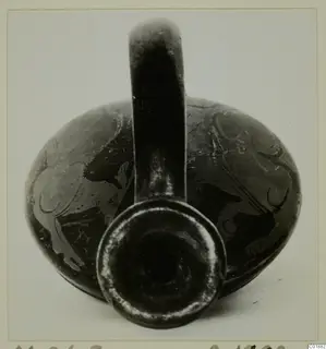Pottery Red Figured Ware vessel with a single strap handle, photographed from the front with its mouth facing the camera