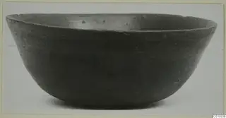Pottery Black Slip I-VI bowl, a wide open bowl with dark, smooth surface seen from the side