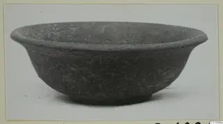 Shallow bowl with a flaring rim and small ring base, photographed against a pale background.