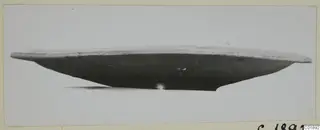 Side view of a shallow bowl, Pottery Plain White VII, with a pale rim and dark body, on a light background