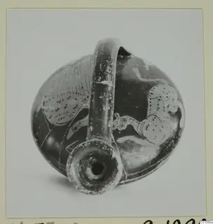 Red figured pottery vessel with a tall strap handle and animal figures, shown from above with the mouth toward the camera